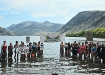 Dozens of wild swimmers protest plans to alter Lake District’s Crummock Water